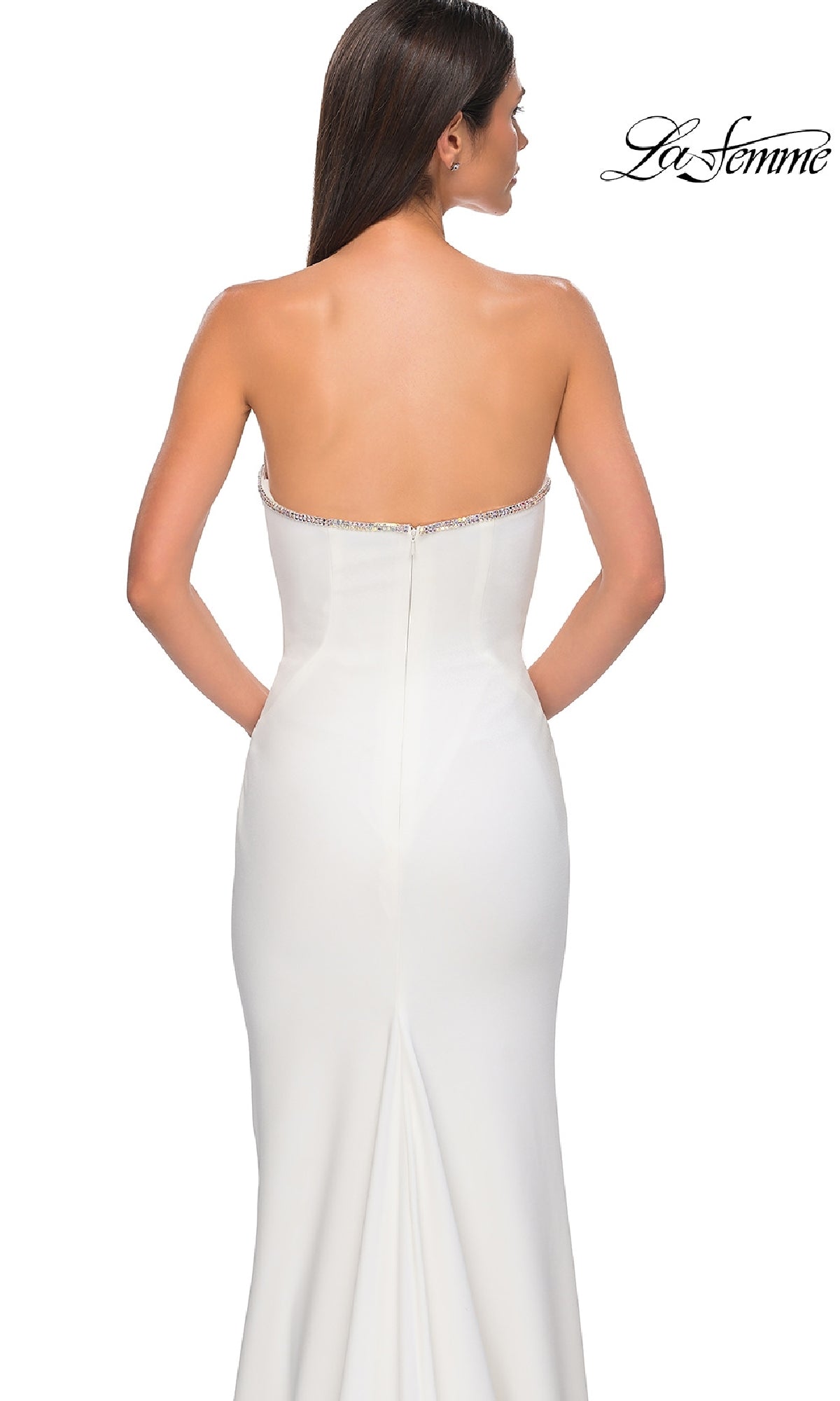 A woman models the Strapless Long Jersey Prom Dress: La Femme 32854 in white, shown from the back with the La Femme logo displayed in the top right corner.